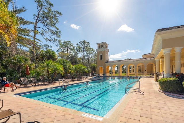 pool with fence and a patio area