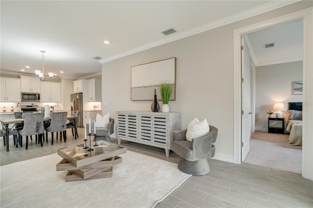 living room with light colored carpet, an inviting chandelier, and ornamental molding