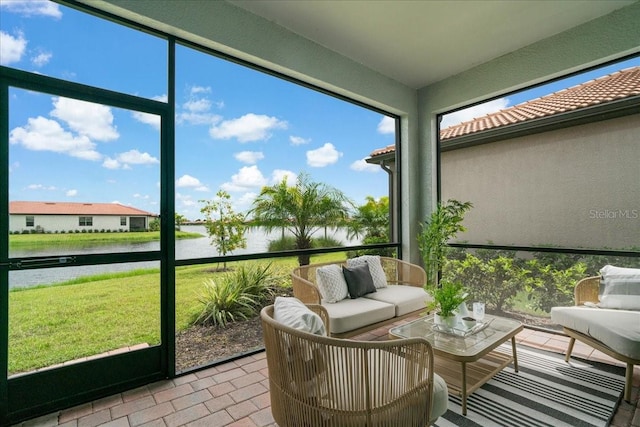 sunroom / solarium featuring a water view