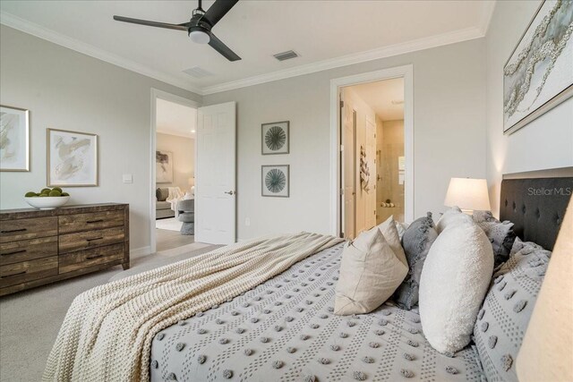 bedroom with ensuite bath, ceiling fan, light colored carpet, and crown molding