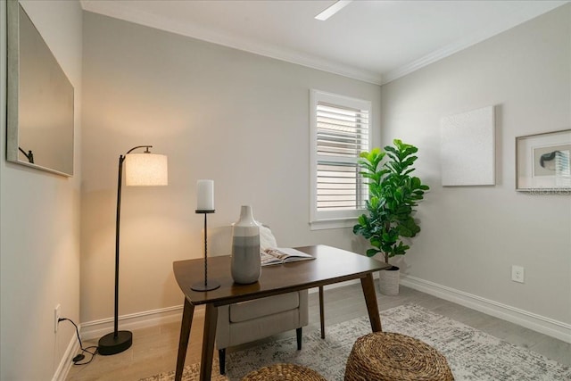 office with ornamental molding and light hardwood / wood-style flooring