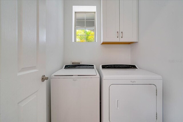 laundry area with cabinets and separate washer and dryer