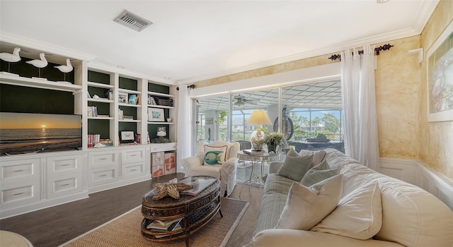 living room with crown molding, wood-type flooring, and built in features