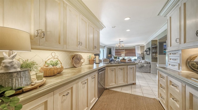 kitchen with light tile patterned flooring, sink, kitchen peninsula, stainless steel dishwasher, and an inviting chandelier