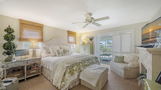 bedroom featuring access to exterior, light colored carpet, and ceiling fan