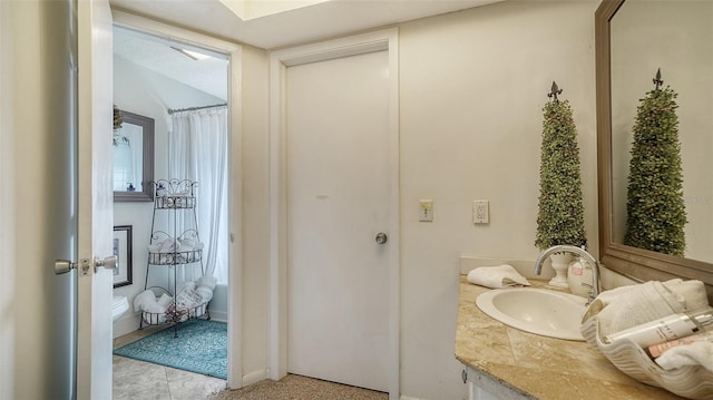 bathroom with vanity, a shower with shower curtain, and a skylight