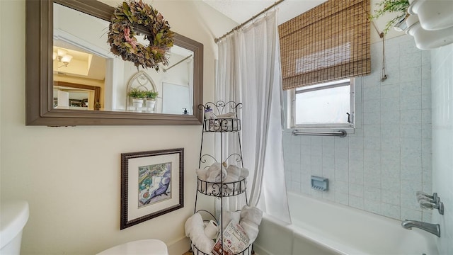 bathroom with toilet and shower / bath combination with curtain