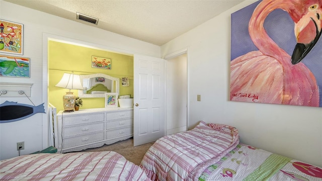 bedroom featuring carpet and a textured ceiling