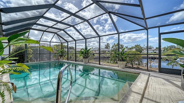 view of pool with a patio, a water view, and a lanai