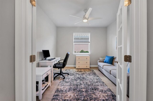 tiled home office featuring ceiling fan