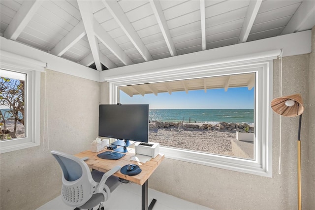 office area featuring vaulted ceiling with beams