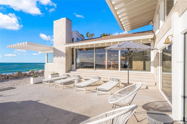 view of patio with a water view