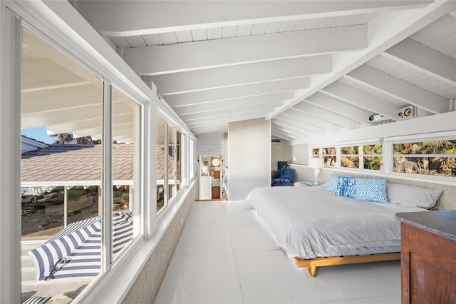 bedroom featuring vaulted ceiling with beams and light tile patterned floors