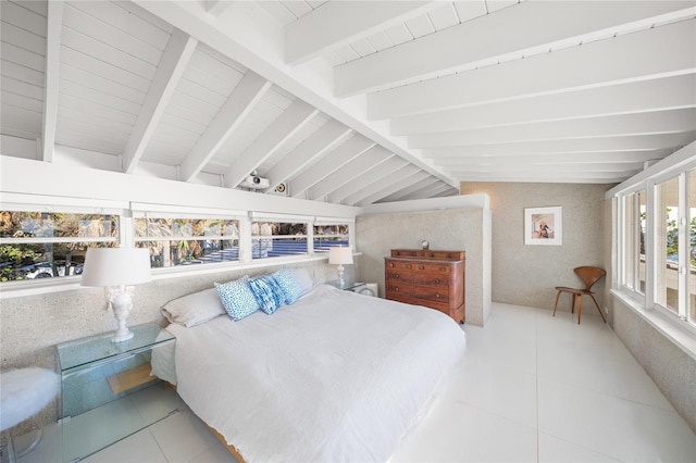 tiled bedroom with vaulted ceiling with beams