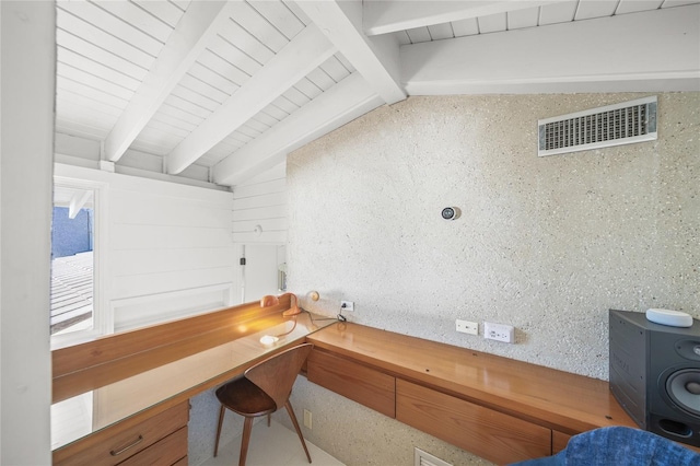 office space featuring lofted ceiling with beams