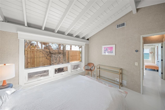 bedroom featuring beam ceiling, multiple windows, and high vaulted ceiling