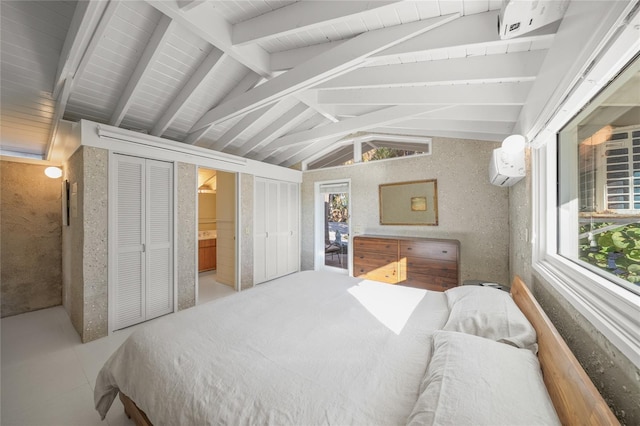 bedroom with vaulted ceiling with beams, connected bathroom, and a wall mounted AC