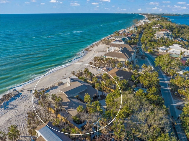 birds eye view of property featuring a beach view and a water view