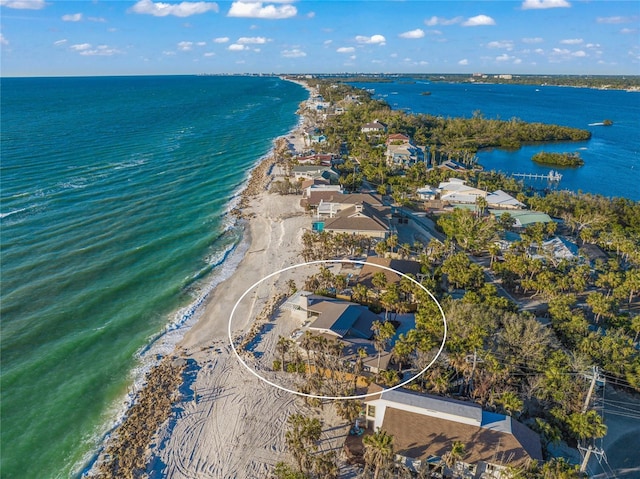 bird's eye view featuring a water view and a view of the beach