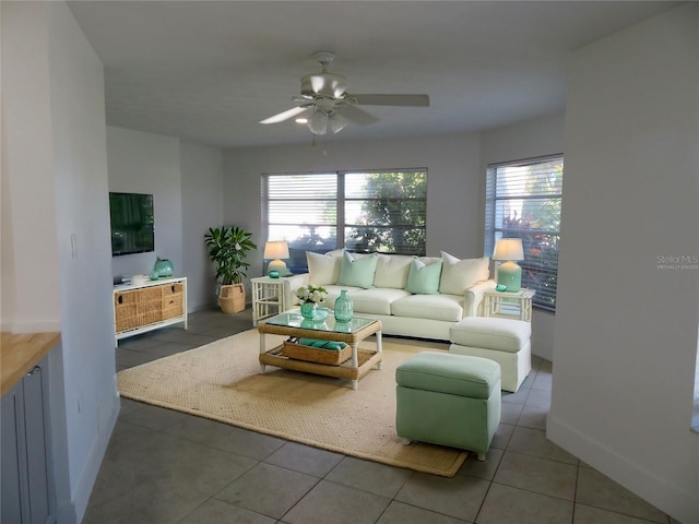 tiled living room featuring ceiling fan