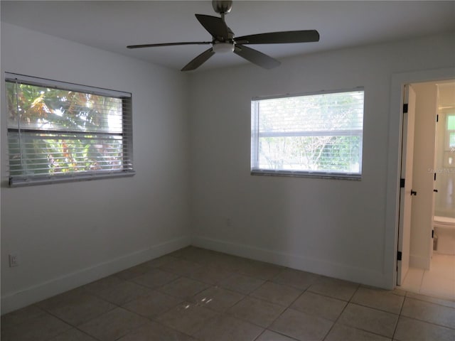 spare room with tile patterned flooring and ceiling fan