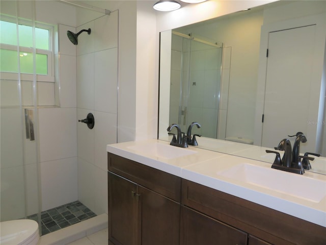 bathroom with walk in shower, vanity, and toilet