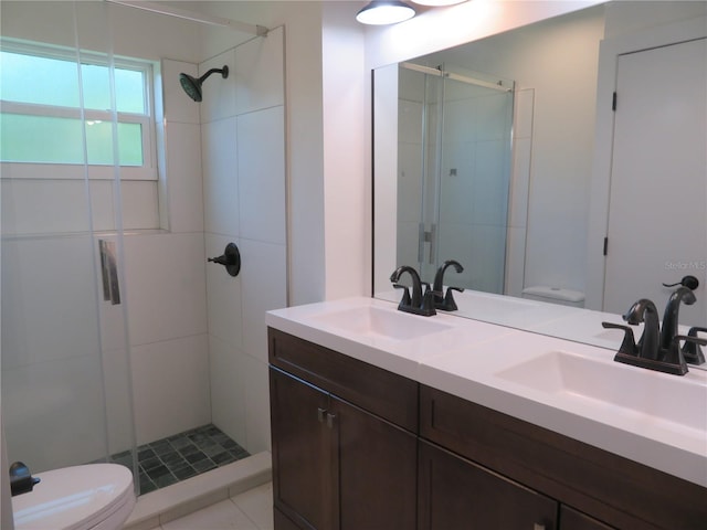 bathroom featuring vanity, tile patterned flooring, toilet, and a shower with door