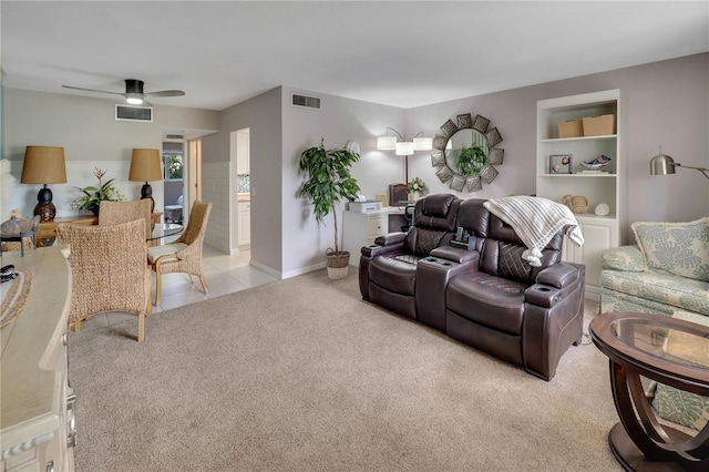 carpeted living room with ceiling fan