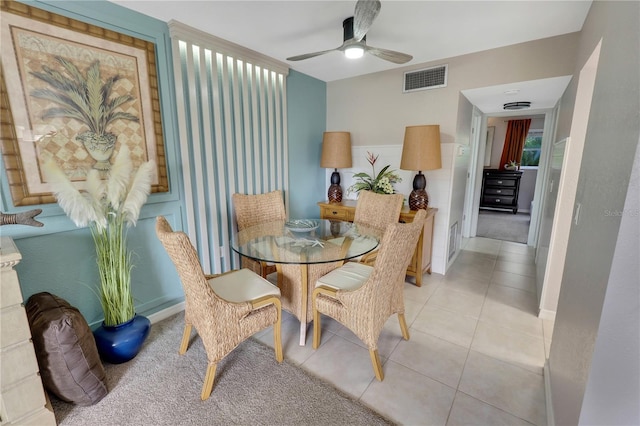 dining space with ceiling fan and light tile patterned flooring