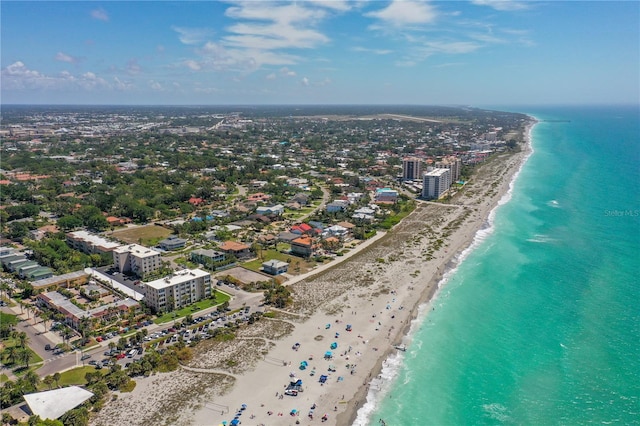 drone / aerial view featuring a view of the beach and a water view