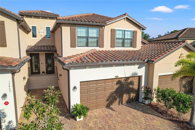 mediterranean / spanish house with a garage