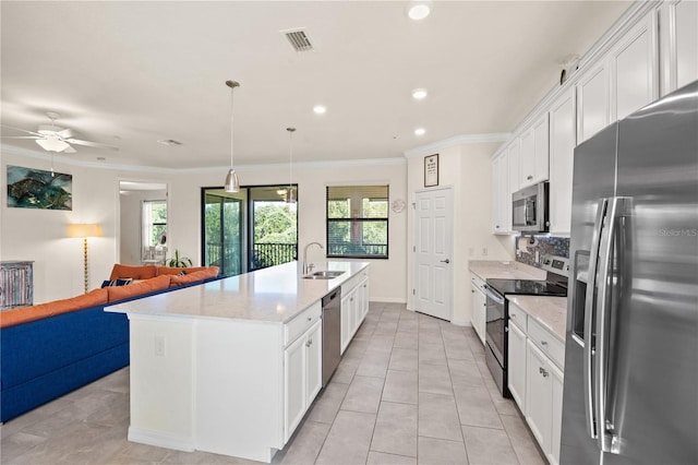 kitchen featuring stainless steel appliances, white cabinetry, a center island with sink, and ceiling fan