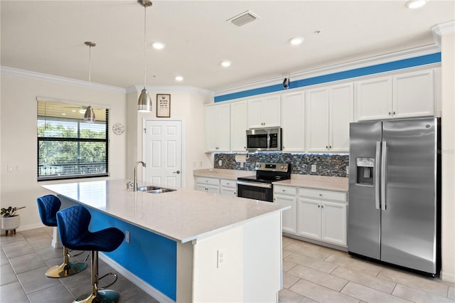 kitchen featuring white cabinetry, appliances with stainless steel finishes, and decorative light fixtures