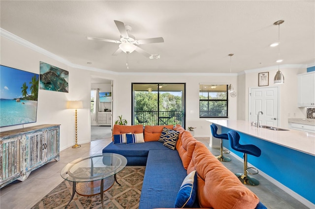 living room with ceiling fan, ornamental molding, light tile patterned floors, and sink