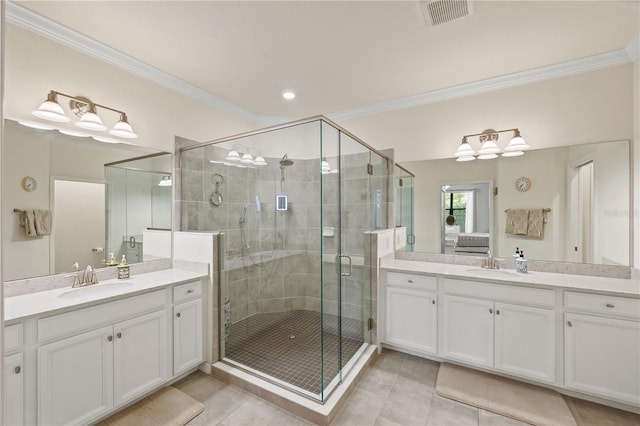 bathroom with walk in shower, vanity, crown molding, and tile patterned flooring