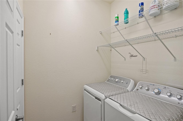 clothes washing area featuring washer and clothes dryer