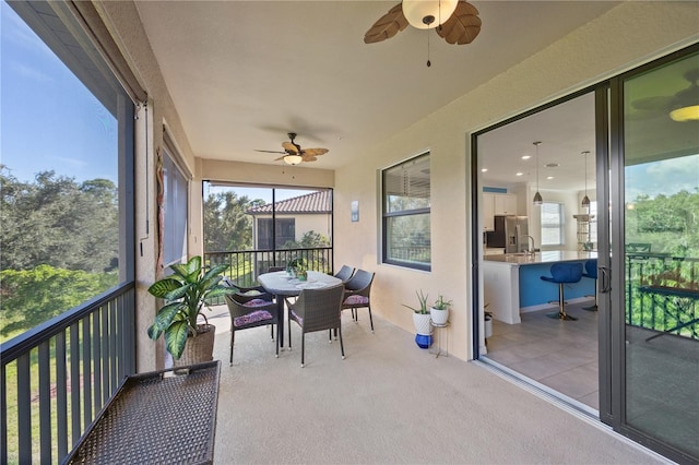 sunroom with sink and ceiling fan