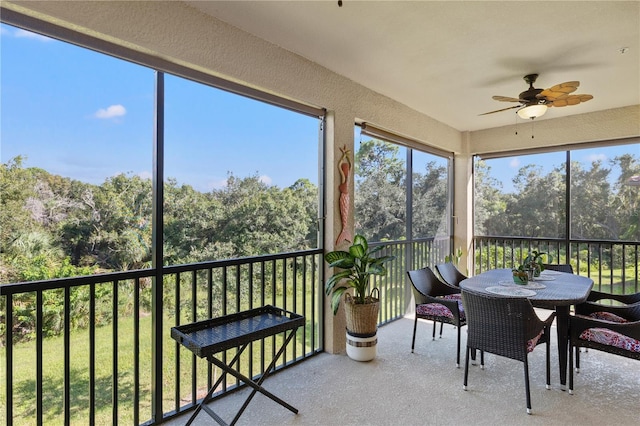 sunroom featuring ceiling fan