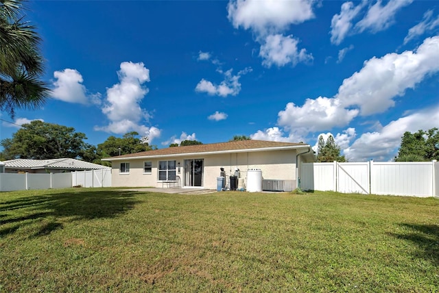 back of house with a yard