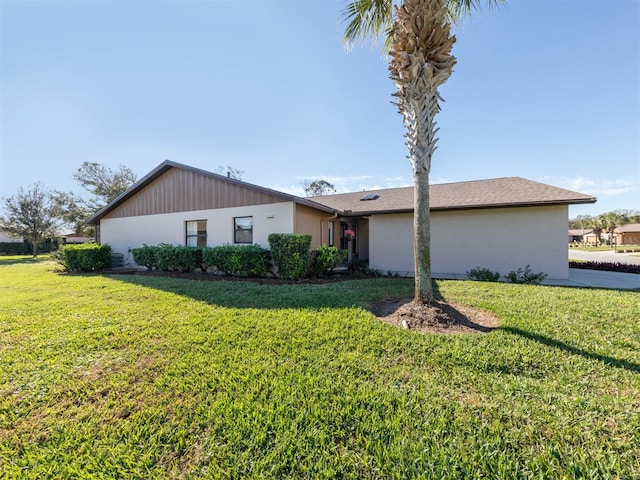 ranch-style house with a front lawn