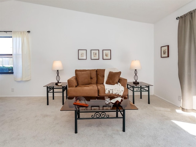 living room with lofted ceiling and light colored carpet