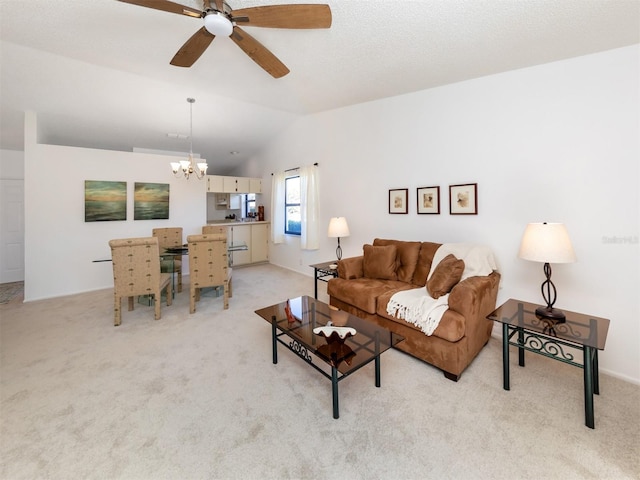 living room with ceiling fan with notable chandelier, lofted ceiling, and light carpet