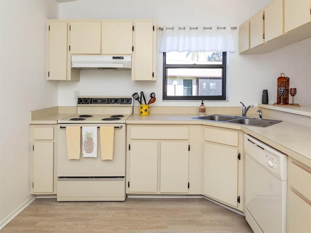 kitchen featuring white appliances, light hardwood / wood-style floors, cream cabinetry, and sink