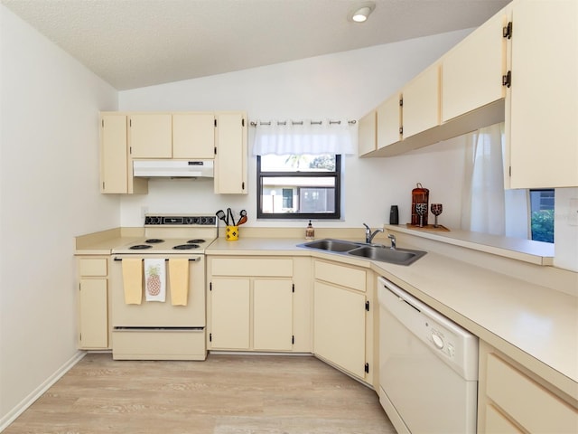 kitchen with light wood-type flooring, sink, lofted ceiling, white appliances, and cream cabinets