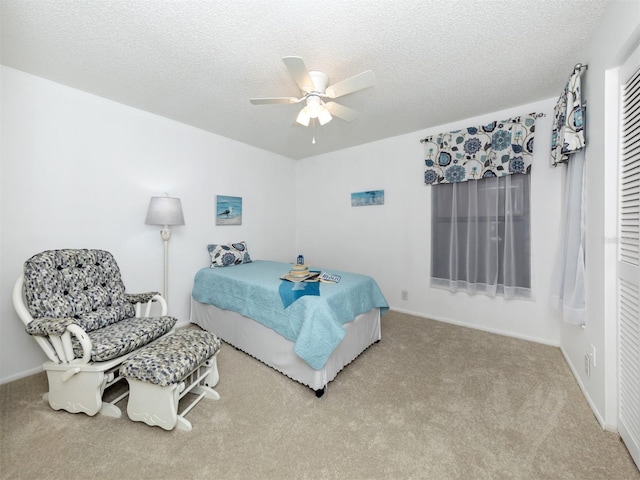 carpeted bedroom with ceiling fan, a textured ceiling, and a closet