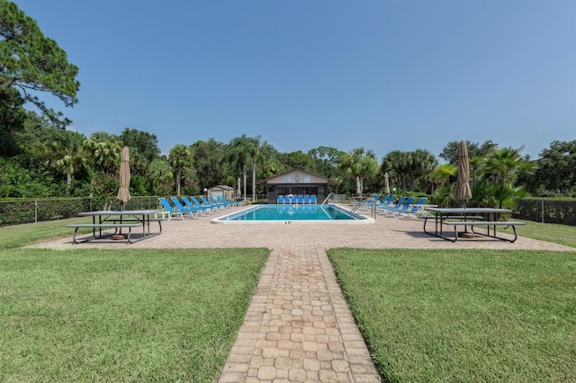 view of swimming pool featuring a lawn and a patio area