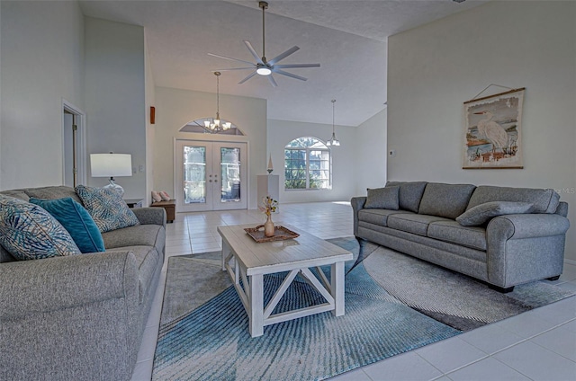 living room featuring french doors, high vaulted ceiling, light tile patterned flooring, and ceiling fan with notable chandelier