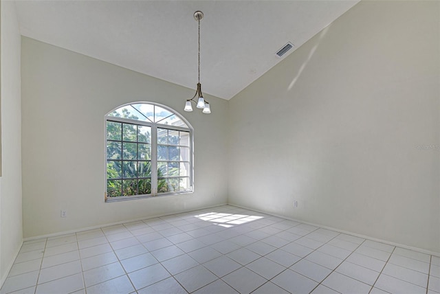 empty room featuring an inviting chandelier, high vaulted ceiling, and light tile patterned floors