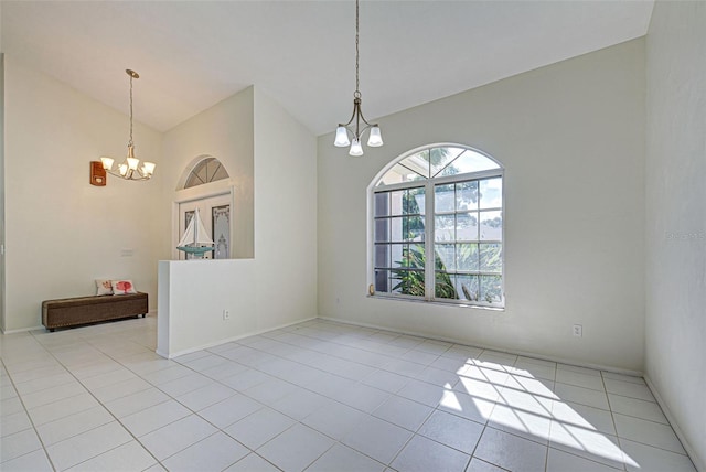 unfurnished room featuring an inviting chandelier and light tile patterned flooring