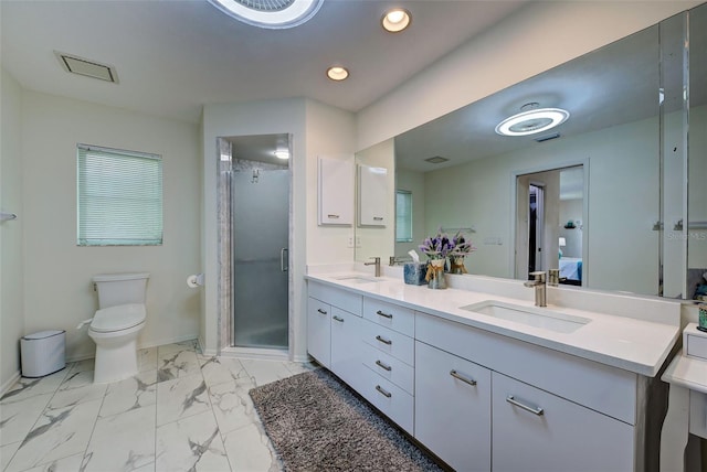 bathroom with toilet, walk in shower, and vanity